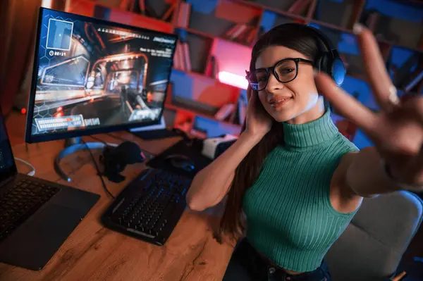 Row of gaming stations with monitors and chairs at COMBO computer club