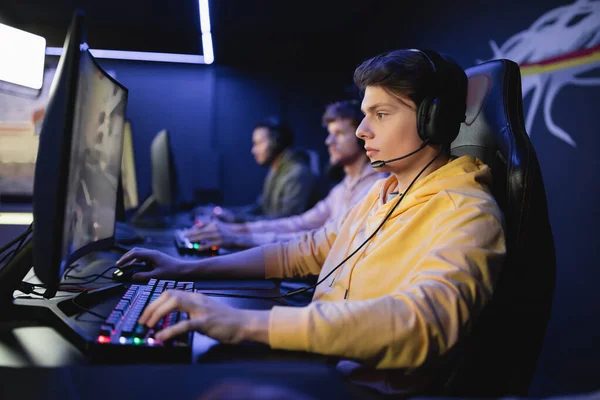 A player mid-session at a COMBO duo desk seat, side view
